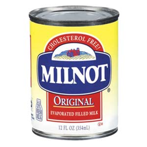 Close up of a red, white, blue and yellow can of Milnot brand Evaporated Filled Milk. 