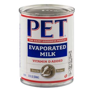 Close up of a red, white and blue can of PET brand Evaporated Milk.  